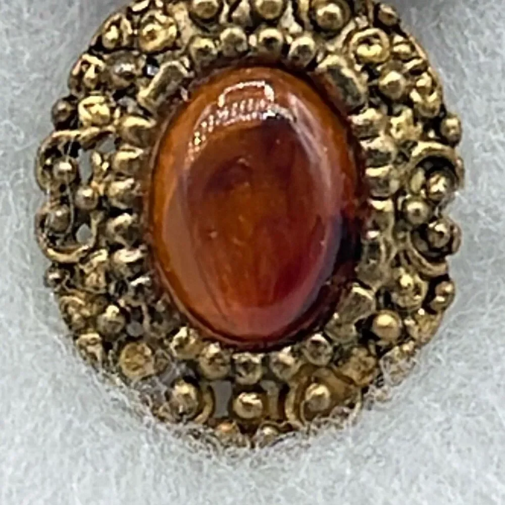 Vintage ornate amber colored brooch.